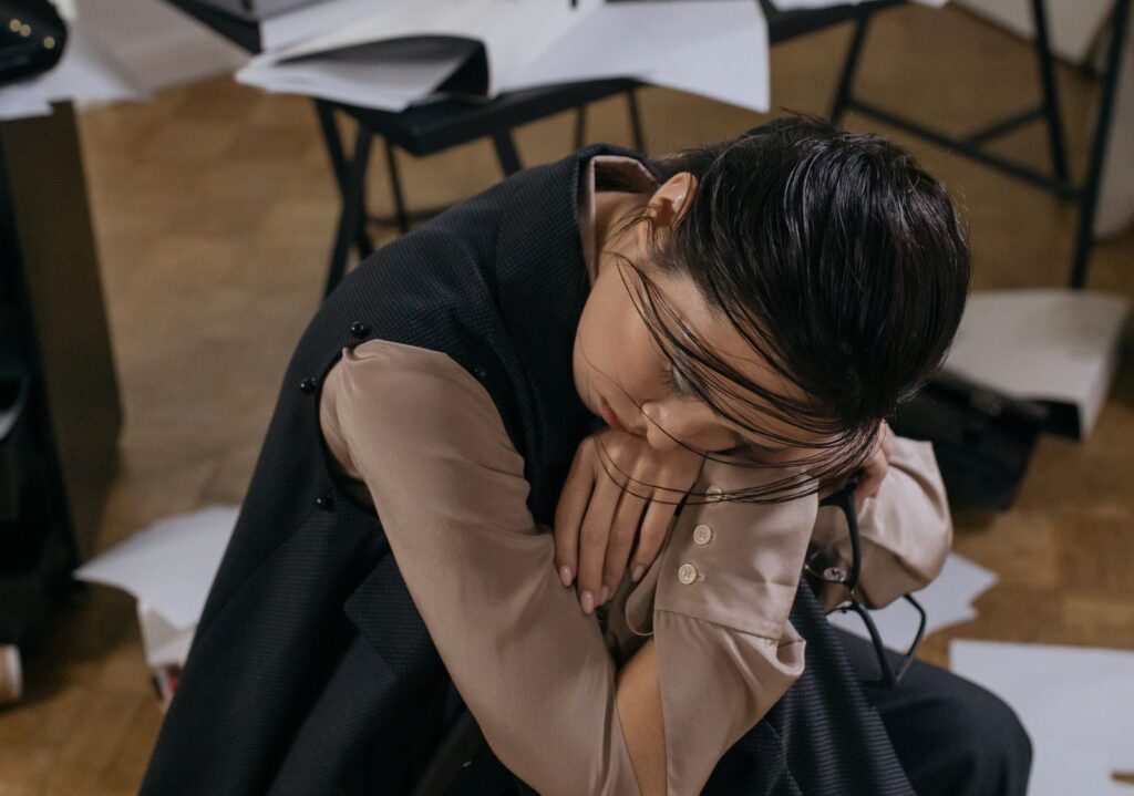 Femme au repos, tête posée sur le genou, fatigue chronique de la ménopause